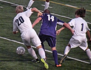Junior defender Brendan Rosenburg fights two O'Fallon panthers for the ball / Photo by Roger Starky