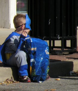 A child takes a break from trick-or-treating / Photo by Roger Starkey