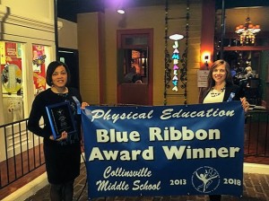 Audrey Hill (left) and Julie Semith with the banner acknowledging CMS as a Blue Ribbon Physical Education Award Winner / Photo courtesy of Audrey Hill