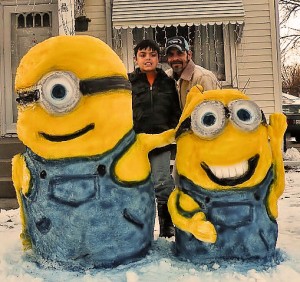 Freddie Novosell Jr. and Freddie Novosell III, creators of the snow minions, from Disney's "Despicable Me," in their yard in the 600 block of N. Keebler / Photo by Roger Starkey