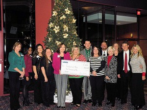Members of UMB Bank, Tote Me Home, Collinsville Charities for Children and the Collinsville Chamber of Commerce with a ceremonial check for $10,000 / Photo by Roger Starkey