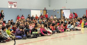Students at Kreitner Elementary School sit quietly at an assembly during which $2,000 was donated to the school's PTA / Photo by Roger Starkey