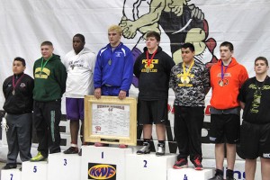 Alfred McIntosh (white shirt) on the podium after winning 3rd place at the IKWF Wrestling State Tournament / submitted photo