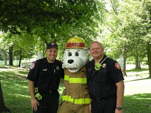Collinsville Fire Department mascot Sparky poses with Mike Harris (pictured on left) and Lt. Frank Arnold / Photo by Roger Starkey